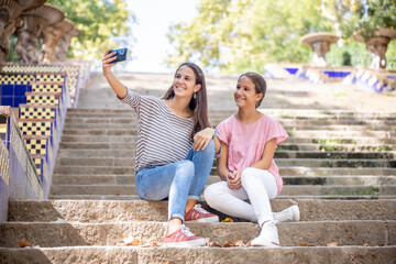 Girls taking a selfie on the park stairs