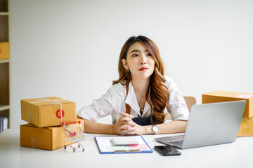 Portrait of Starting small businesses SME owners female entrepreneurs working on receipt box and check online orders to prepare to pack the boxes, sell to customers, sme business ideas online.