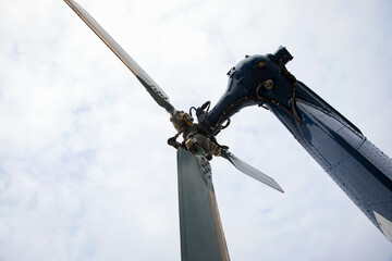 tail rotor of helicopter over cloudy sky background