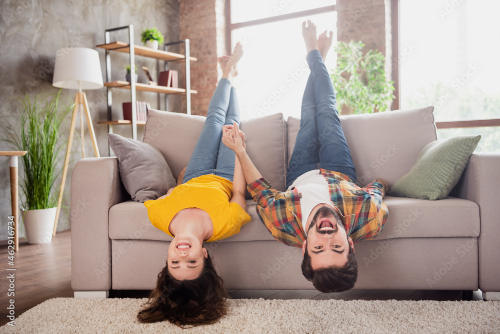 Canvas Prints photo of beautiful funky young lovers dressed casual clothes having fun lying sofa upside down smili