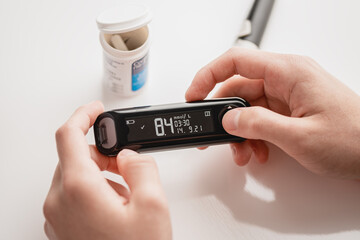 Medicine, glycemia, healthcare and people concept, The diabetic measures the level of glucose in the blood. World Diabetes day, 14 November.