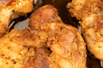 Fried pieces of meat in a frying pan, close-up, selective focus.
