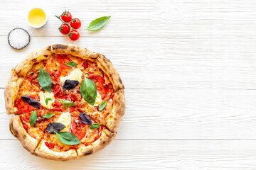 Italian pizza with tomatoes cheese and basil, top view