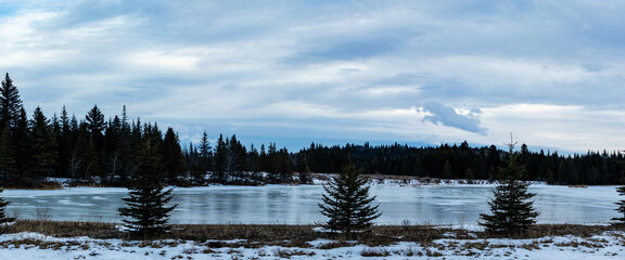 Frozen ponds with a skiff of snow. Sibbald Creek Trail, Alberta, Canada