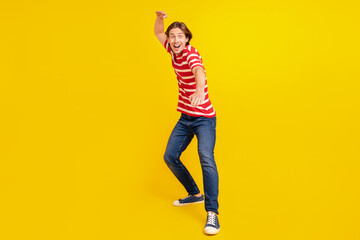 Fototapeta na wymiar Full length body size view of attractive cheerful crazy guy dancing fooling isolated over bright yellow color background