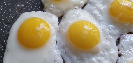 Fresh quail eggs are fried in a pan. Healthy breakfast of scrambled eggs.