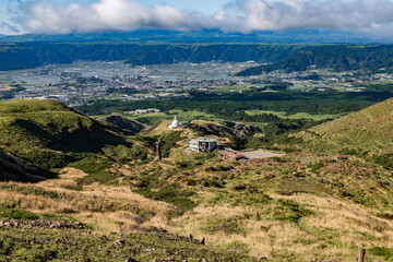 Fototapeta na wymiar Scenic high angle view on Aso town, abandoned buildings, and walk way from mountain Aso in Kyushu, Japan