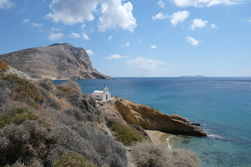 Fototapeta na wymiar Anafi island - View on the coast, Anargyri beach lonely sandy shore and the eponymous small church. Cyclades islands, Greece 