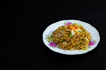 Indonesian fried noodle on black background for restaurant menu