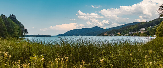 Beautiful alpine summer view with reflections at the famous Woerthersee, Maria Woerth, Kaernten, Austria