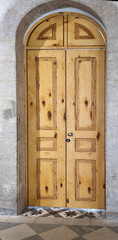 Wooden door made in a sophisticated classic antique style using  modern simple structure of lacquered regular wood