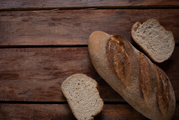 Freshly baked bread on old wooden background