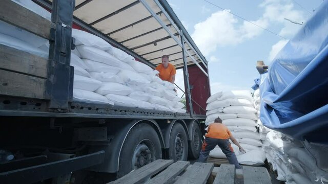 Stacking of bags on truck moving to warehouse