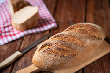 Freshly baked bread on old wooden background