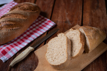 Freshly baked bread on old wooden background