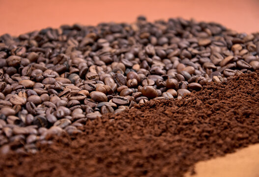 Pile of roasted coffee beans and ground instant coffee stock images. Different types of coffee beans close-up stock photo. Coarse and fine ground coffee stock images