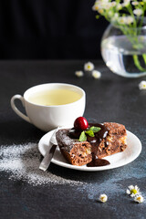 Still life with chocolate cake and cup of green tea