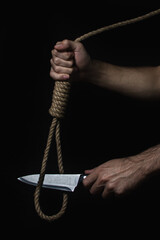 Hands cut the gallows with a knife. Solving difficult and critical situations. Helping those in...