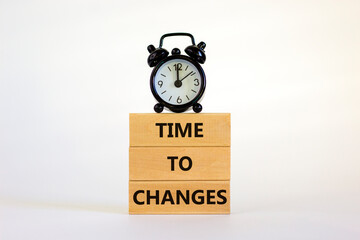 Time to changes symbol. Concept words 'Time to changes' on wooden blocks. Black alarm clock. Beautiful white background. Business and time to changes concept. Copy space.