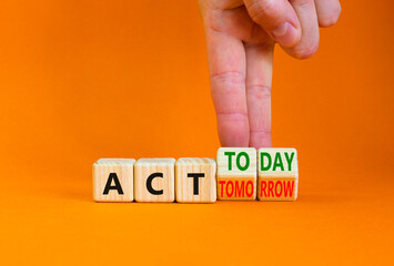 Act today not tomorrow symbol. Businessman turns wooden cubes, changes words act tomorrow to act today. Beautiful orange table, orange background. Business, act today or tomorrow concept, copy space.