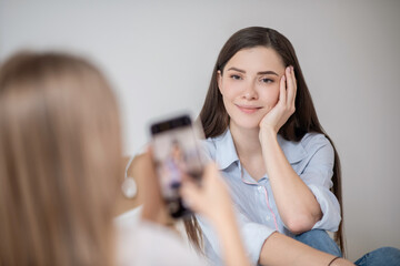 A girl making photo of her pretty mother