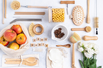 A set without plastic with a cotton bag, a glass jar, green and recycled dishes, spices, wooden letters. Zero waste, environmentally friendly concept. Lying flat, top view, copy space