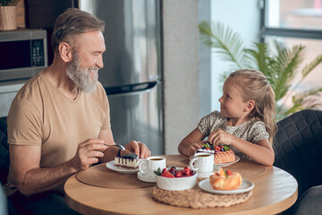 Dad and his daughter having breakfast together at home