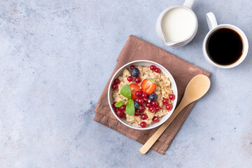 Fototapeta na wymiar Healthy breakfast set on grey background. The concept of delicious and healthy food. Granola, coffee and milk. Top view, copy space.