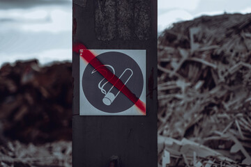 Close-up photo of rubbish and garbage in the dump with the sign of no smoking