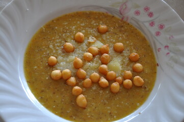 Brown lentil soup in a bowl with bread balls