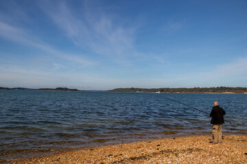 person fishing on the beach