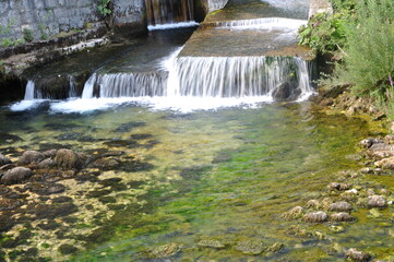 Small waterfall in the forest. Small stream waterfall on spring forest.