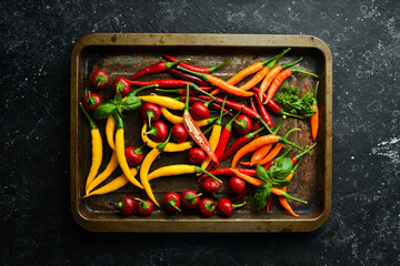 Fresh hot pepper on a metal tray. Food background. Top view.