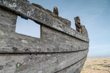 Close up of wooden frame and nails of abandoned fishing boat wreck at Dungeness, Kent, England