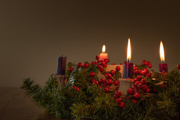 Advent wreath with three candles lit with copy space