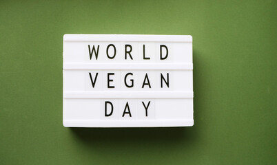 World vegan day greeting top view. Green background banner