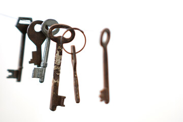 A different old retro keys from different locks hanging on string, selective focus