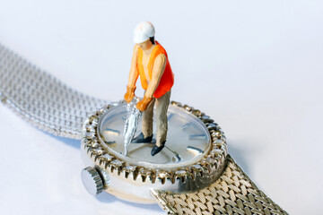 closeup of miniature people working on diamond watch
