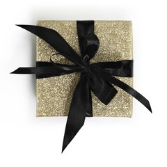 golden glittering gift box package with black ribbon bow isolated on white background, top view