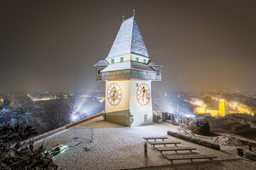 The famous landmark of Graz in a cold and dark winter night with some snow short before christmas