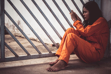 Portrait of women desperate to catch the iron prison,prisoner concept,thailand people,Hope to be...