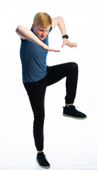 portrait of a red-haired guy in a blue t-shirt and jeans on a white isolated background. teenager...