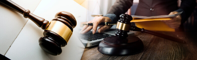 Law theme, mallet of the judge, law enforcement officers, evidence-based cases and documents taken into account.