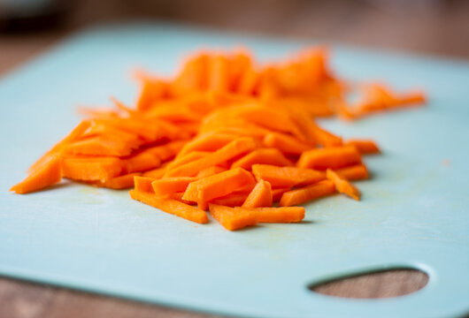 Chopped carrots on a plank. Cutting carrots into strips