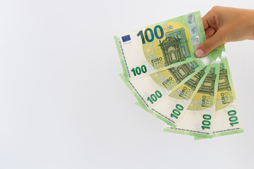 Hand holding euro money or giving money. On a white background with copy space.