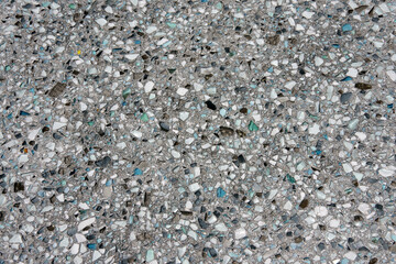 Full frame view of a terrazzo surface made with broken tiny pieces of turquoise and black colored glass