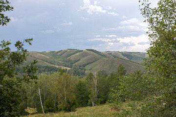 Ural mountains in Bashkiria, clouds with clouds float over the forest