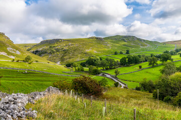 Obraz premium A view of the road leading to Gordale Scar near Malham, Yorkshire, UK on a summers day