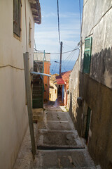 Narrow street on Corfu, Greece, that descends to the sea
