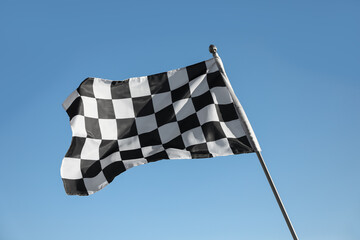 Checkered finish flag on light blue background